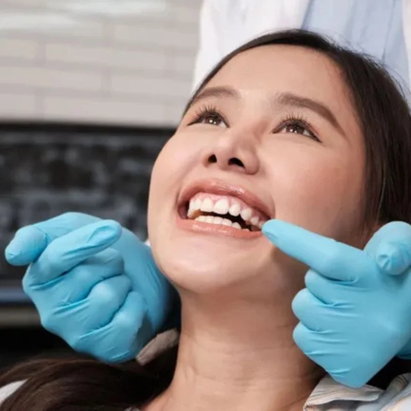 Dentist examining patient’s teeth during dental implant consultation at Fairmont Dental Centre in London Ontario