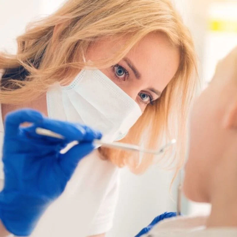 Close-up of London dentist examining patient’s teeth before wisdom teeth removal at Fairmont Dental Centre in London Ontario