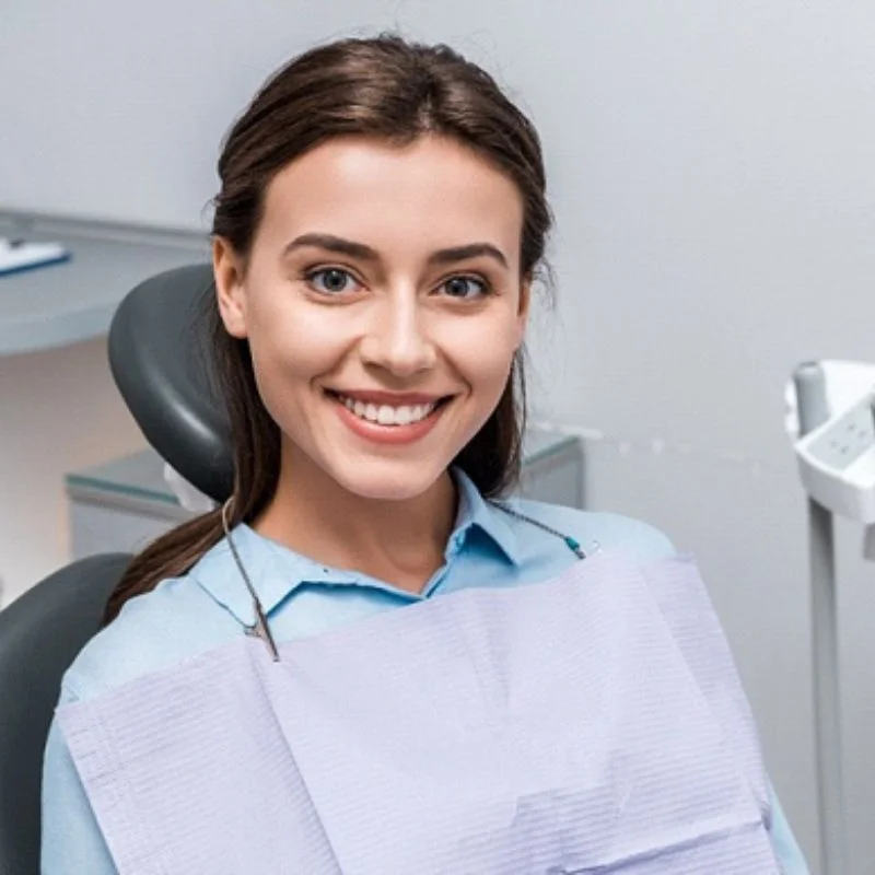 Smiling patient sitting in dental chair after root canal consultation at Fairmont Dental Centre in London Ontario