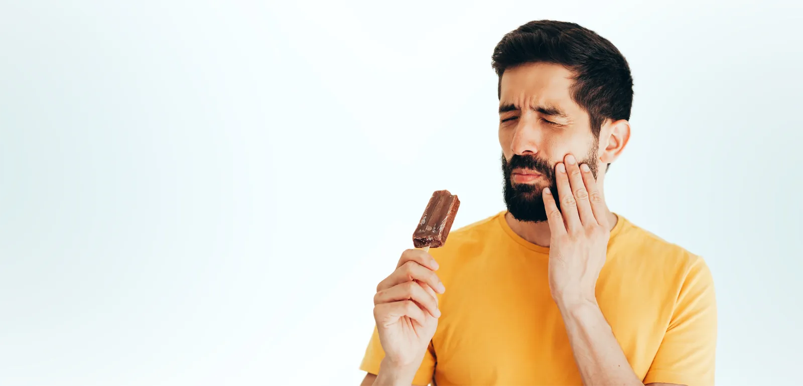 Man holding jaw in pain due to dental emergency before treatment at Fairmont Dental Centre in London Ontario